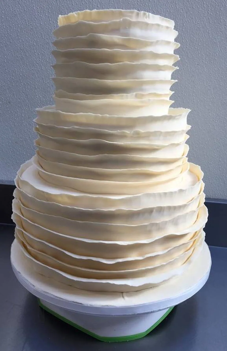 Three-tier white ruffled buttercream celebration cake by Easy Sweets