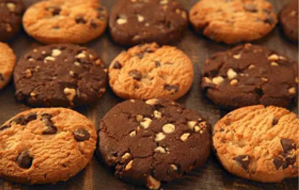 Assorted chocolate chip, double chocolate and oatmeal cookies arranged on a platter